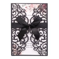 Close-up of laser-cut hollow pattern and silk ribbon on navy blue wedding invitation - Black Khaki