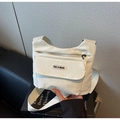 Detail view of water-resistant nylon crossbody bag with adjustable wide fabric shoulder strap - Off-white