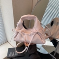 Pink patent leather handbag with bow accents and adjustable strap for crossbody wear - Pink