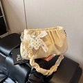 Pleated cream shoulder bag featuring pearl heart charm and lace bow detail - Yellow