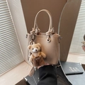 Chic beige lychee leather bucket bag with knot handle and cute teddy bear charm - Apricot (With Pendant)
