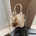Chic white lychee leather bucket bag featuring a cute teddy bear charm and knotted handle - White (With Pendant)