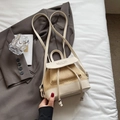 Mini straw and cream leather backpack with Acme Girl branding on white bedding - Rice White (No Pendant)