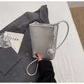 Detail of silver crossbody phone bag with litchi grain texture and knotted strap - Silver