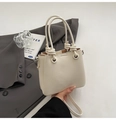 Ivory lychee textured bucket bag with unique knot handles and adjustable crossbody strap - White (Without Charm)