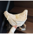 White nylon crescent crossbody bag with colorful striped strap on wooden stairs - White