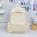 Close-up of minimalist cream nylon backpack with GDMNU embroidery and drawstring side pockets - Off-white