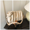 Detail of cream pleated crossbody bag showing soft PU texture and braided handle - Off White