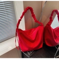 Detailed macro view of the bright red canvas tote with pleated elastic shoulder strap - Burgundy