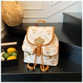 Close-up of vintage bucket bag with KMKA bear prints and leather trim on wooden stairs - White