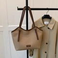 Beige faux leather tote bag with dark brown straps and wavy rim on khaki coat - Khaki (No Pendant)