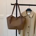 Brown lychee leather tote bag with adjustable gold buckle strap on a sleek hanger - Brown No Pendant