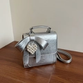 Silver metallic pleated handbag with large bow and pearl heart charm accessory - Silver