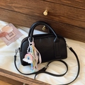 Black pebbled leather Boston bag with colorful rainbow charm and pearl ribbon detail - Black with Pendant
