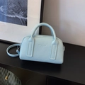Light blue lychee leather Boston handbag with detachable shoulder strap on black stand - Blue Without Charm