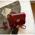 Detail of burgundy patent leather shoulder bag with golden metallic rectangular twist lock - Burgundy