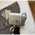 Glossy silver rectangular crossbody bag with golden square lock and adjustable strap - Silver