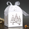 White laser-cut Christmas tree candy box with elegant organza ribbon on dark wood surface - 5*5*8CM / White