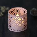 Pink geometric laser-cut paper lampshade with warm LED candle on wood surface - Pink