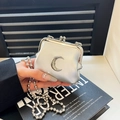 Mini silver kiss-lock crossbody bag with metallic finish and crescent moon ornament - Crescent Style / Silver