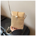 Detail of hand-woven crossbody bag with elegant pearl clasp and slim leather strap - Khaki