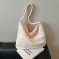 Pink and white tweed tote bag with Jollyhouse brand label on black leather sofa - Light Pink