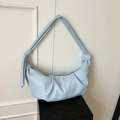 Chic light blue pleated croissant shoulder bag with knotted strap and textured leather finish - Blue