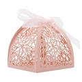 Detail of pink laser-cut wedding favor box featuring floral lace and white ribbon bow - Pink