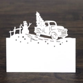 Detail of white laser-cut Christmas place card with snowman and truck on wooden table - 10*10CM / White
