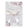 Detail view of laser cut white wedding card with silk bow and floral watercolor accents - White