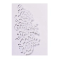 Macro detail of laser-cut rose patterns on elegant white wedding invitation card - White