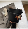 Detail of black lychee grain bucket bag featuring a silver buckle and Pegasus charm - Black with Pendant