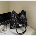 Close-up of black quilted hobo bag with colorful stitching and brand label detail - No Pendant / Black