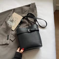 Chic black pebbled leather bucket bag with silver buckle and adjustable shoulder strap - Black