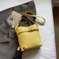 Chic yellow lychee texture bucket bag with silver buckle strap and adjustable shoulder strap - Yellow