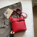 Chic red lychee textured leather bucket bag with silver buckle and thin strap - Red