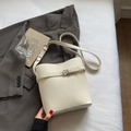 Chic off-white lychee pattern bucket bag with silver buckle and thin shoulder strap - White