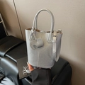 Silver pebble leather bucket bag with top handle and elephant charm decoration - Silver