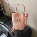 Elegant pink lychee leather bucket bag with cute elephant charm and adjustable strap - Pink