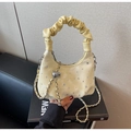 Detail of cream pleated cloud bag featuring rhinestone embellishments and silver chain - Yellow