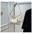 Detail of off-white faux leather crossbody bag with silver punk rings and zipper accents - White