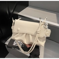 Detail of off-white ruched handbag featuring a pearl heart charm and knotted strap - Cream White With Pendant