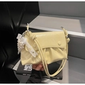 Detail of cream pleated shoulder bag featuring pearl lace charm and glossy leather texture - Yellow with Pendant