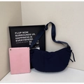 Detail of navy nylon hobo bag showing adjustable strap and minimalist crescent shape - Blue