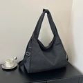 Large black and white checkered canvas tote bag with wide shoulder strap in daily setting - Black