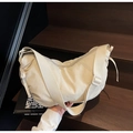 Minimalist cream white dumpling bag with adjustable shoulder strap and crescent shape - Off-white