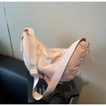 Minimalist light pink nylon dumpling shoulder bag with adjustable wide strap - Pink
