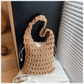 Detail of hollow knit tote bag featuring woven texture and white drawstring inner pouch - Khaki