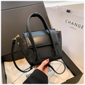 Close-up of black PU leather handbag with gold hardware displayed in a premium gift box - Black