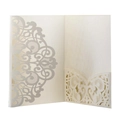Macro detail of laser-cut wedding invitation sleeve with elegant hollow pattern - Ivory